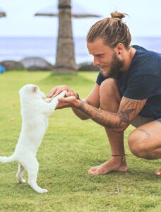man holding hands with dog